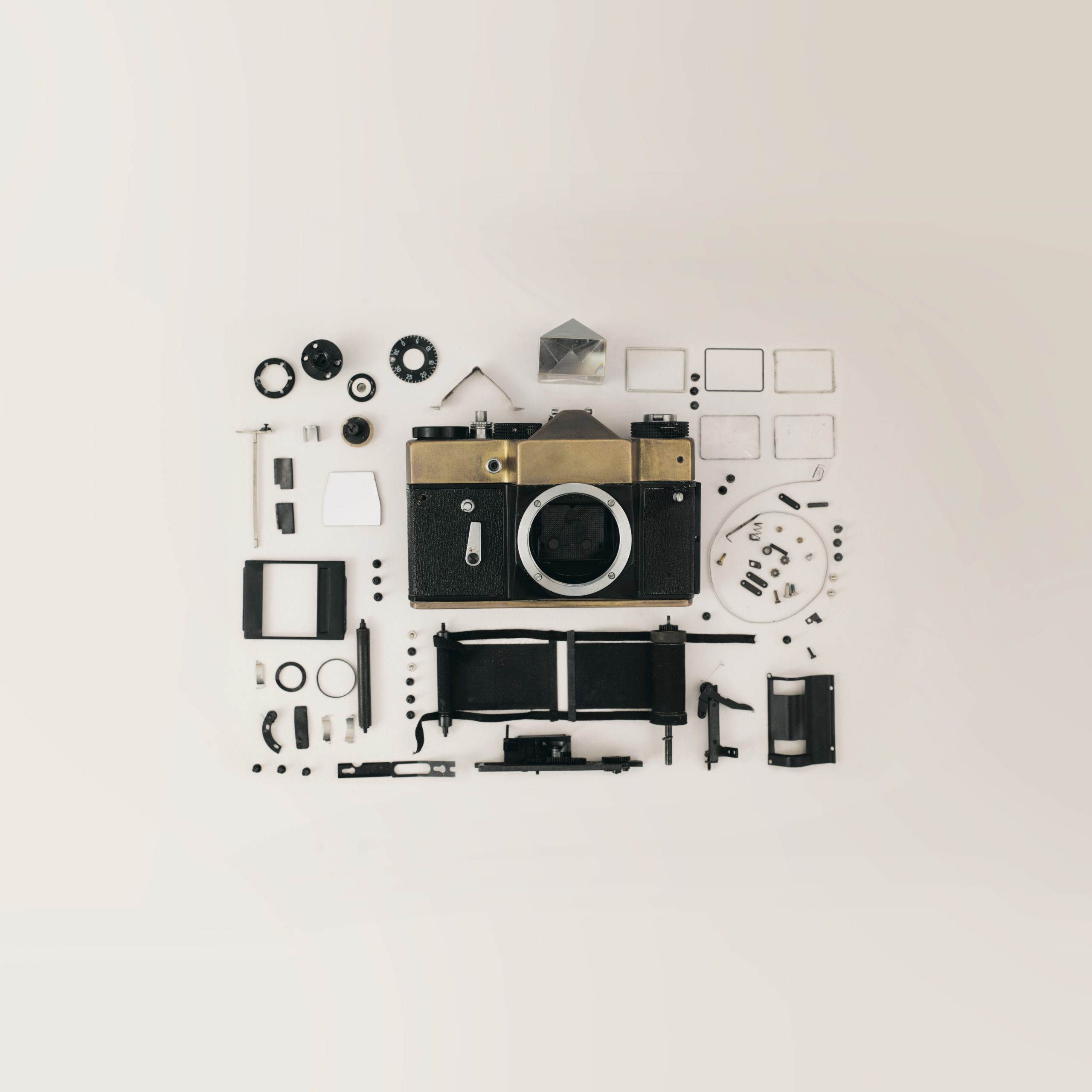 Photo of parts of a 35 mm camera laid out on a table