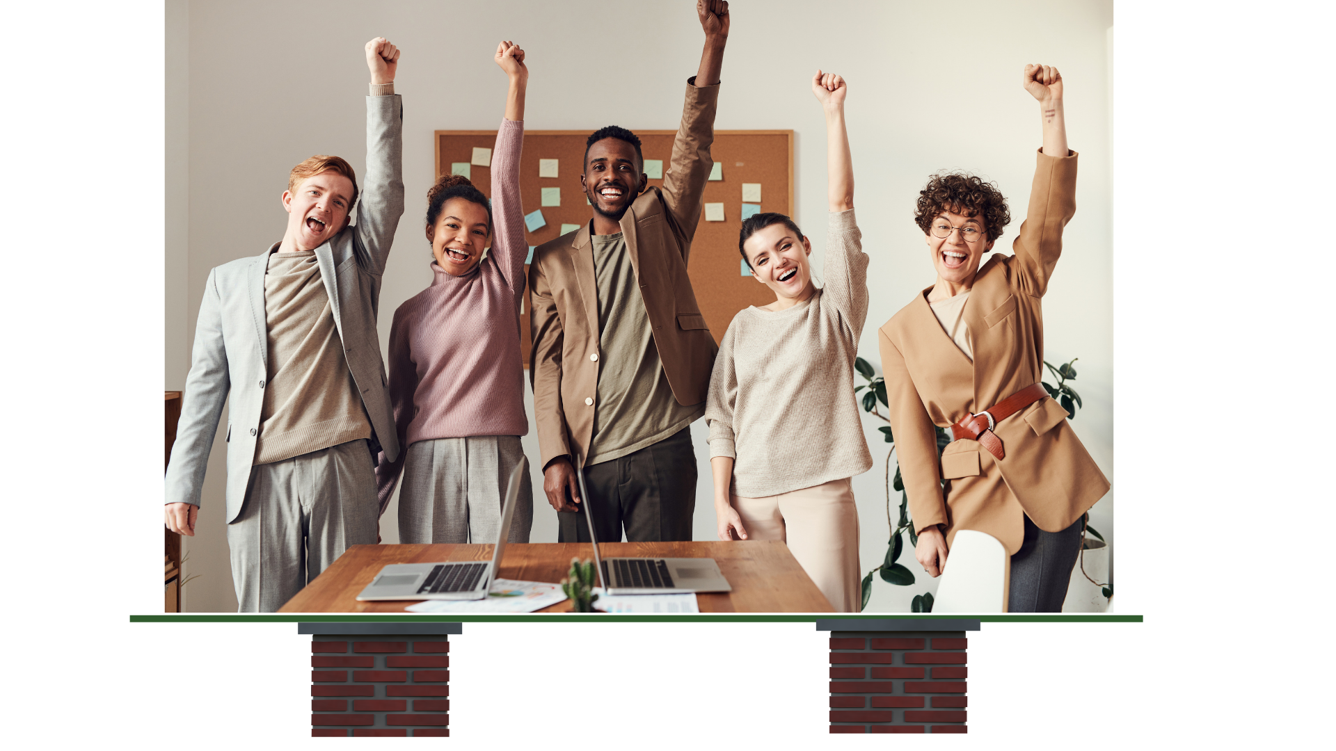 Several team members smiling with hands in the air, celebrating. The photo is balanced on a line supported by two brick columns.
